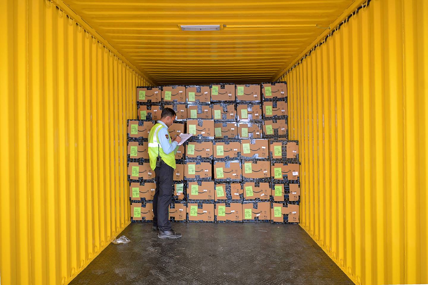 An employee of Amazon India checks products loaded in a truck before being despatched for delivery.