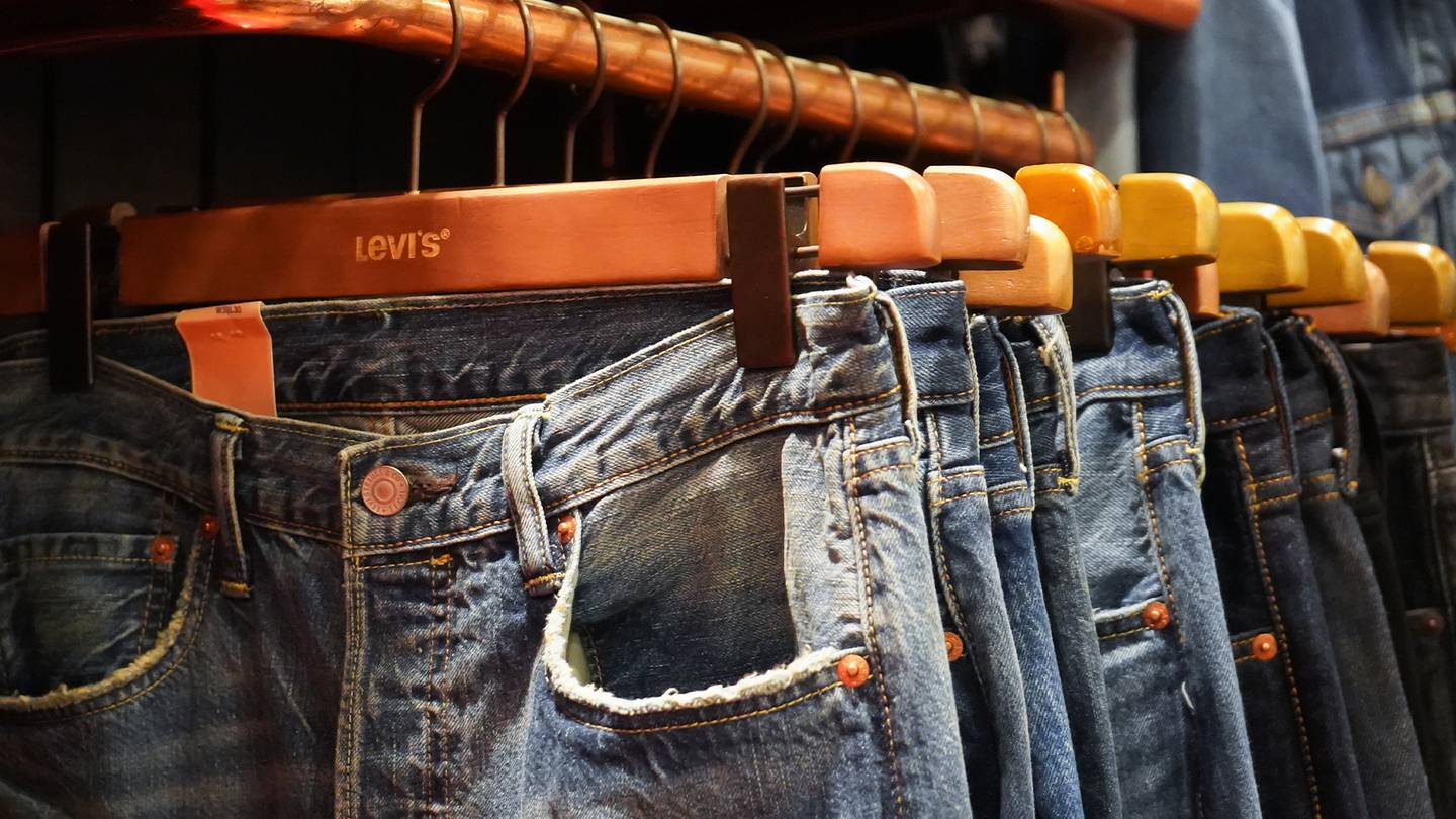 Jeans hang on a rack in a Levi's store.