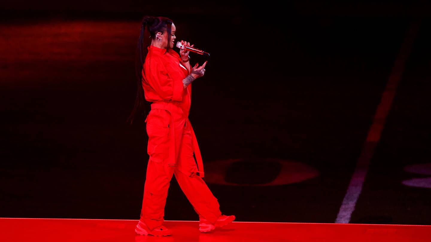 Rihanna on stage at Super Bowl half time show, wearing Salomon and Maison Margiela MM6 sneakers.
