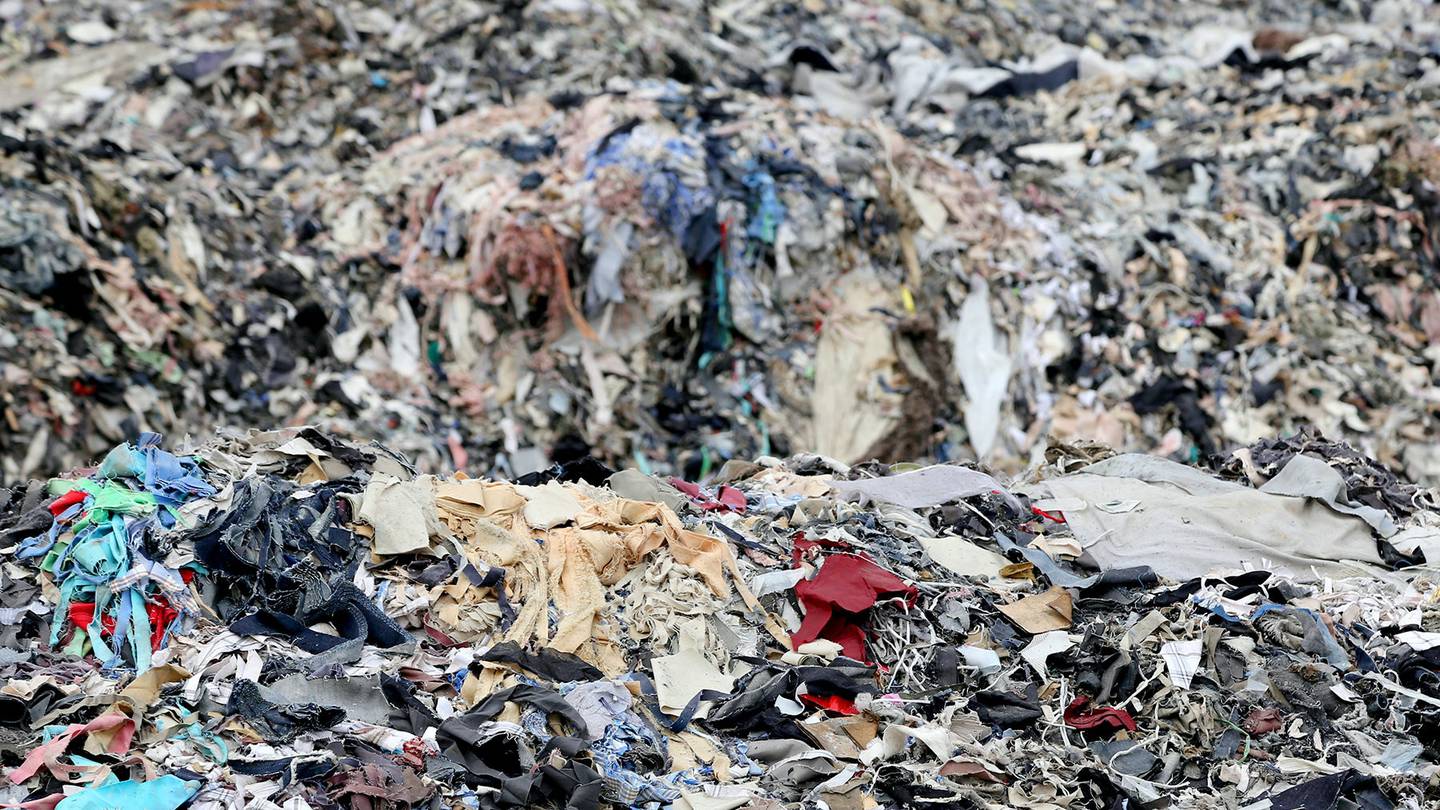 A pile of used clothing and textile waste.