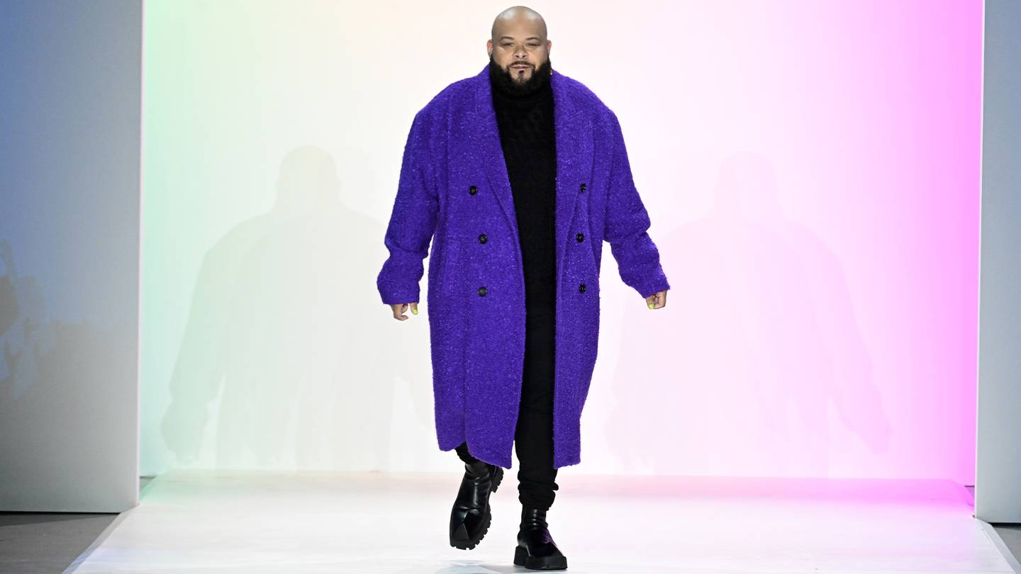 Sergio Hudson dressed in a purple robe on the runway finale.