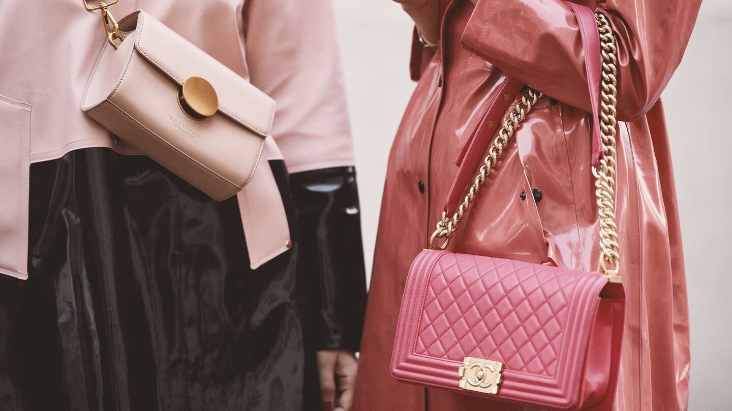 An influencer wears a pink Chanel handbag.