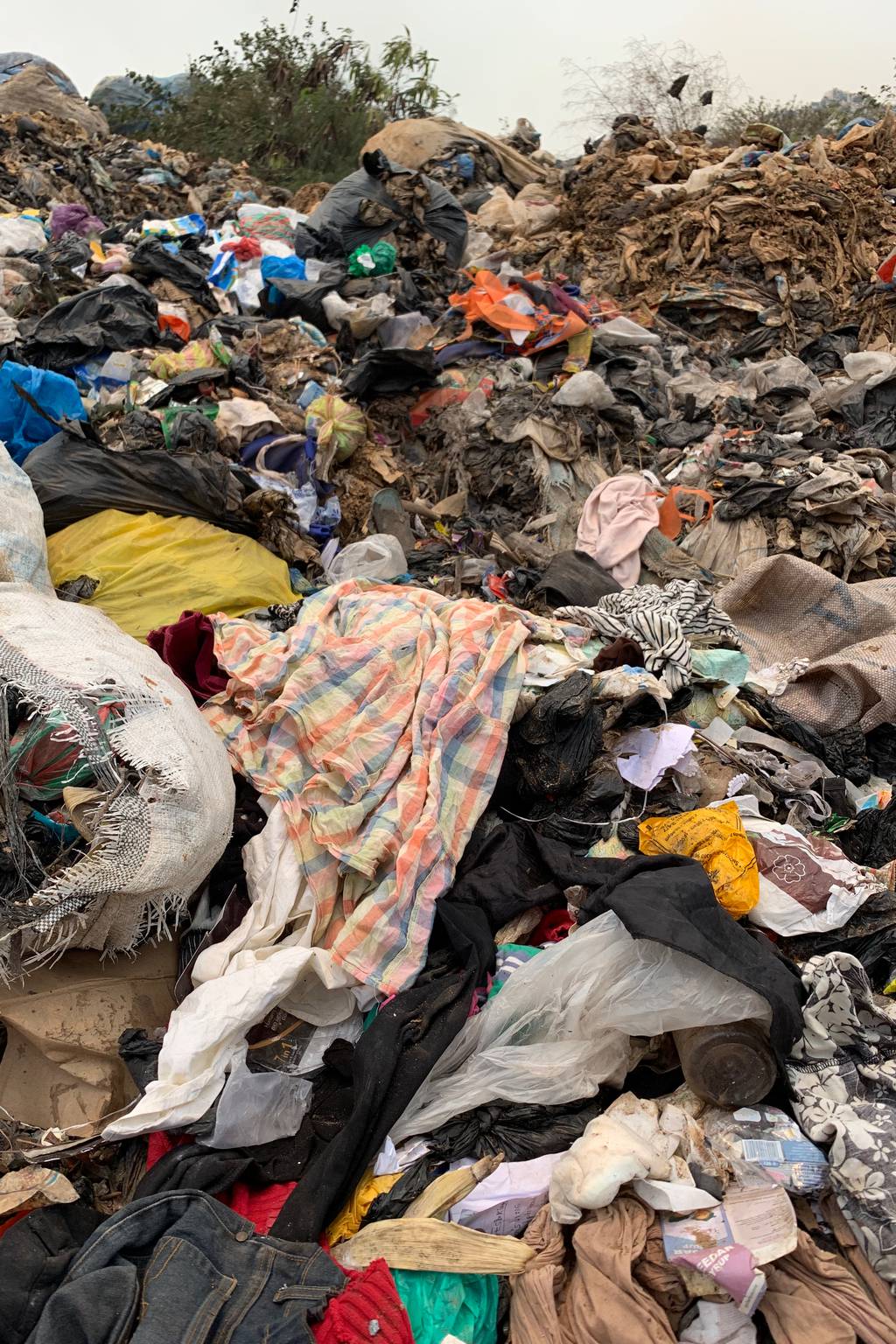 Clothing waste mounting in the Kpone landfill in Accra. Maxine Bédat.
