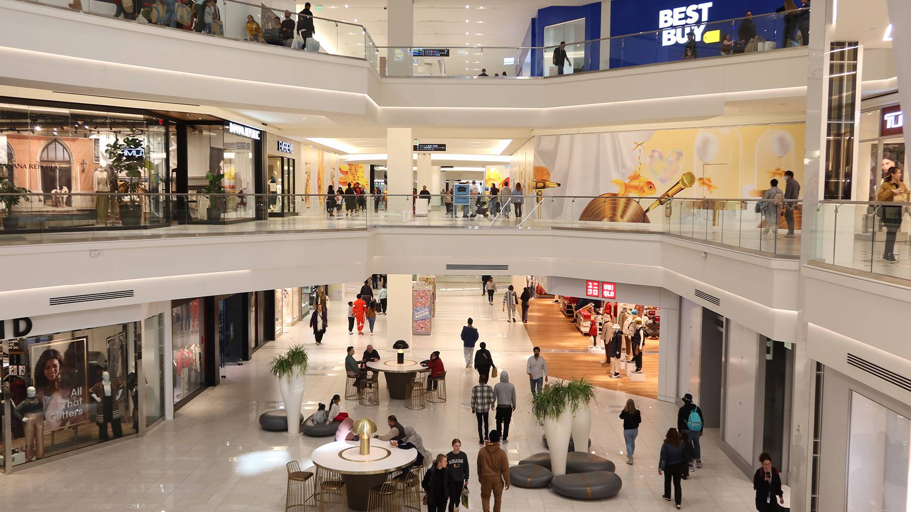 A shopping mall showing a multi-level interior of stores.