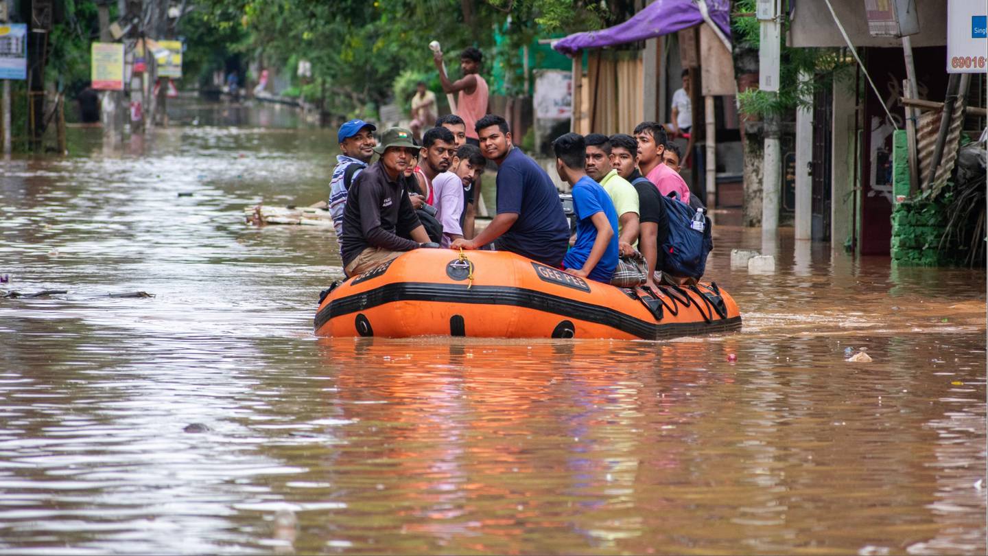 National Disaster Response Force (NDRF) personnel rescue people from waterlogged area, after heavy rainfall, in Guwahati, India.