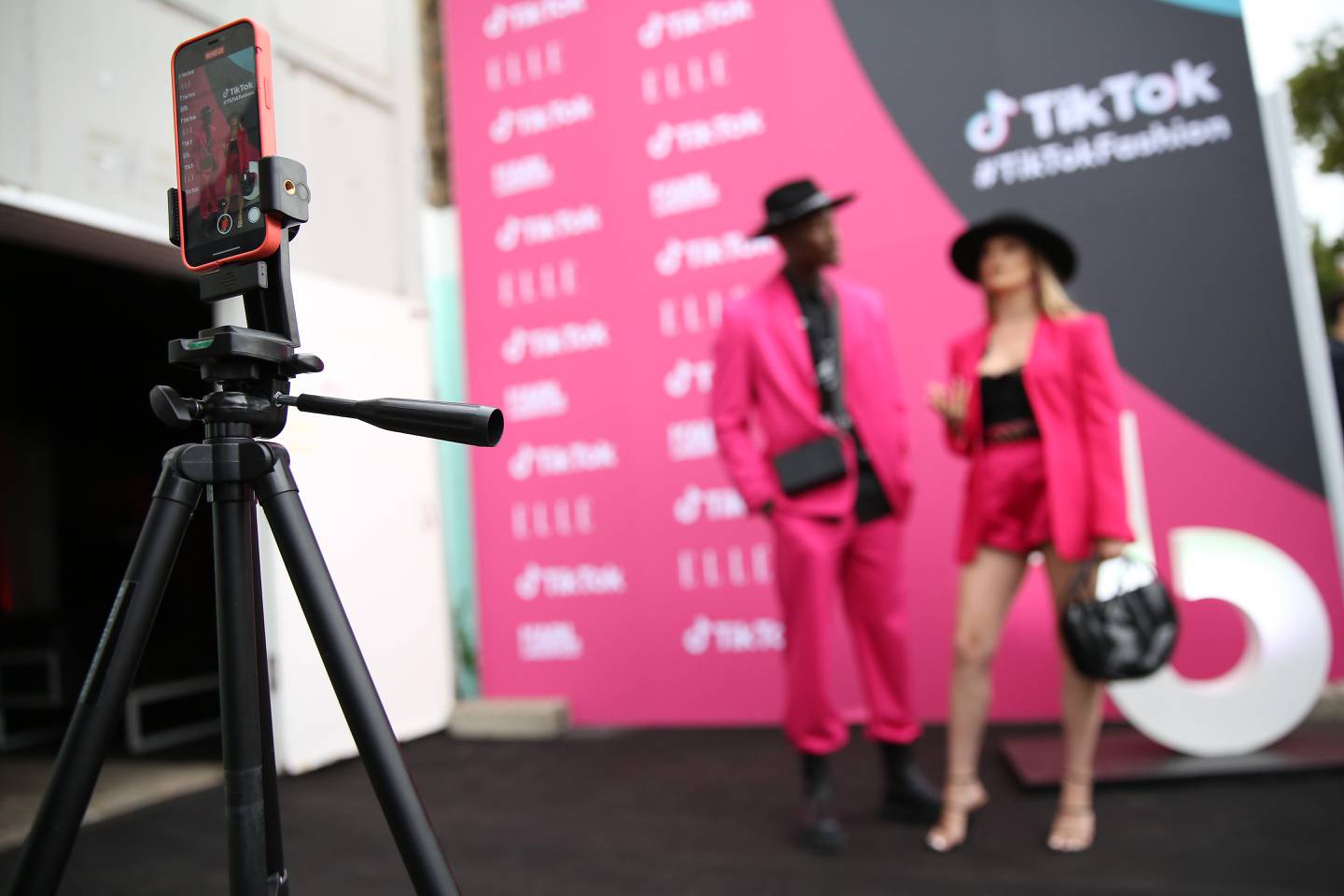 Participants walking along a red carpet as they attend TikTok's "The Future of Fashion" event in Berlin.
