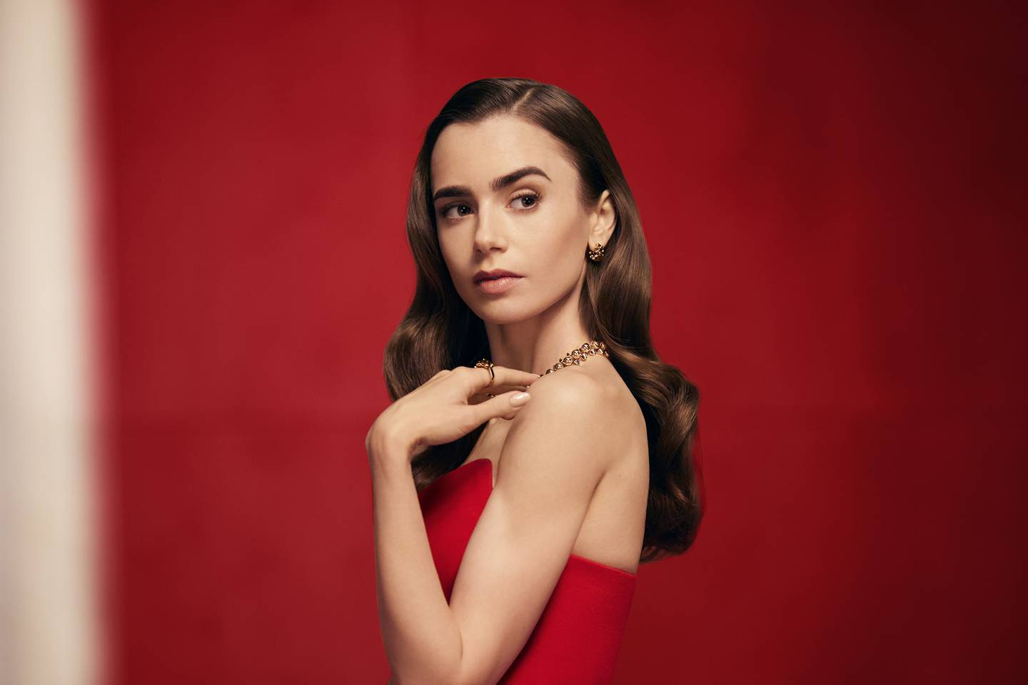 Lily Collins wears jewellery from Cartier's "Clash" collection for the brand's 2021 holiday campaign. Cartier.