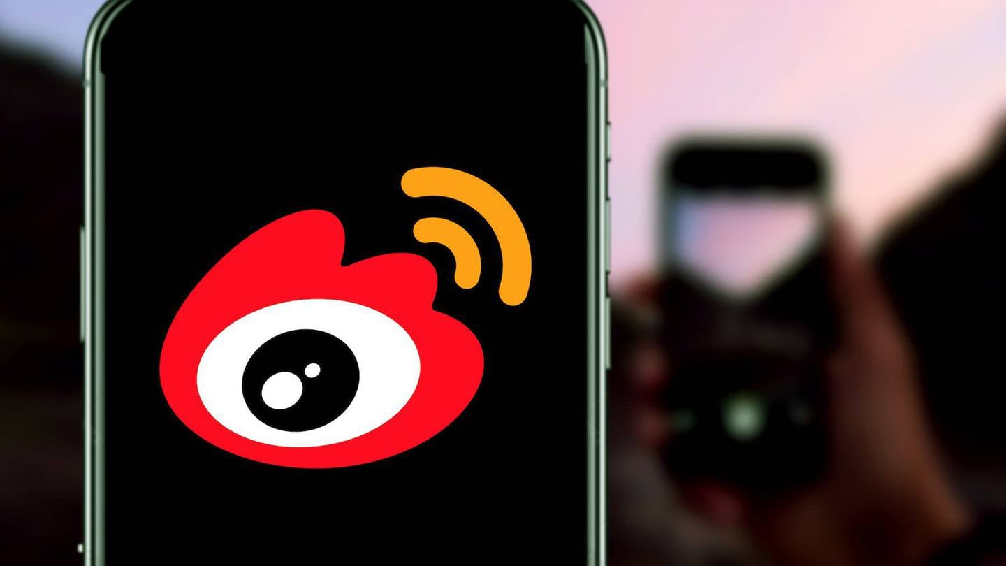 Weibo logo on a smartphone home screen.