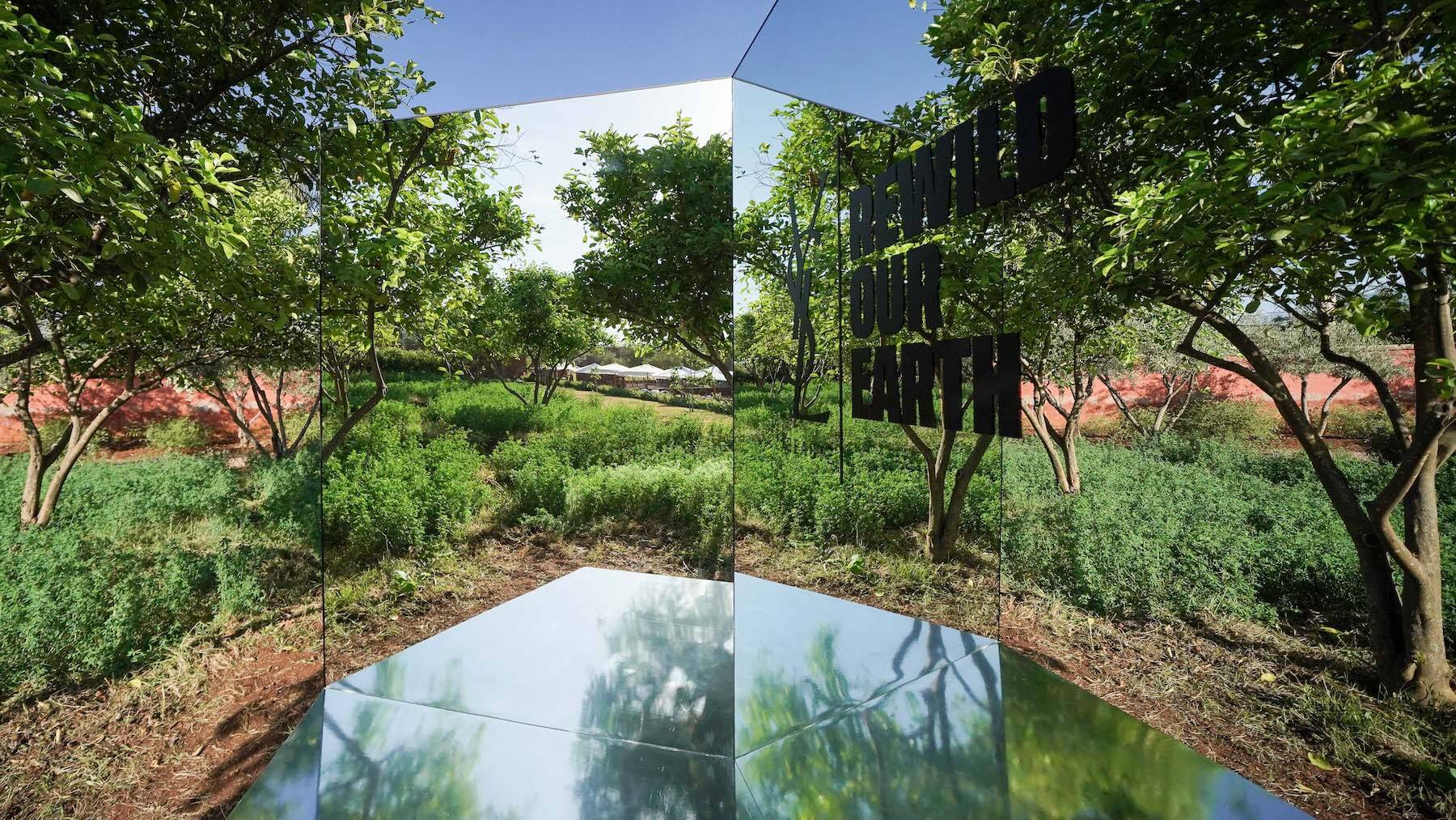 A view of YSL Beauté's Ourika Community Gardens, with a mirrored platform sculpture.