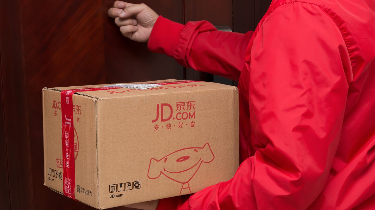 Courier from JD.com delivering a parcel. Shutterstock.