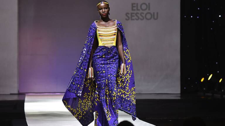 A model presents a creation by label Eloi Sessou during a fashion show marking the 170th anniversary of Dutch manufacturer of African luxury VLISCO in Abidjan