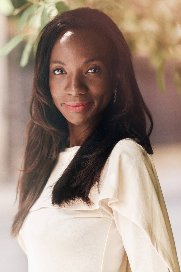 Laureen Kouassi-Olsson, founder and chief executive of Birimian Ventures. Laureen is in a profile shot wearing a white long sleeved dress.