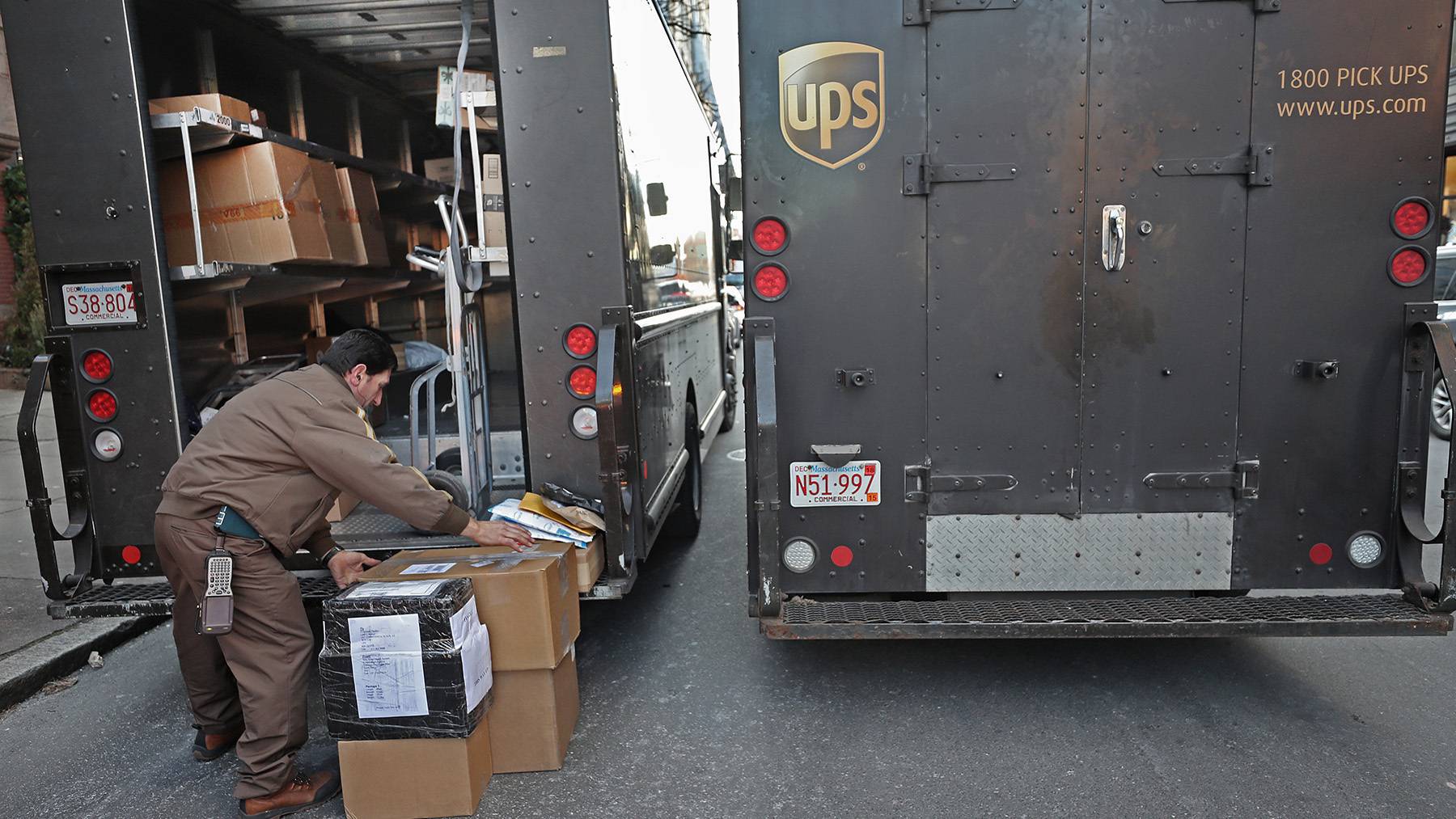 UPS driver loading packages into a truck.