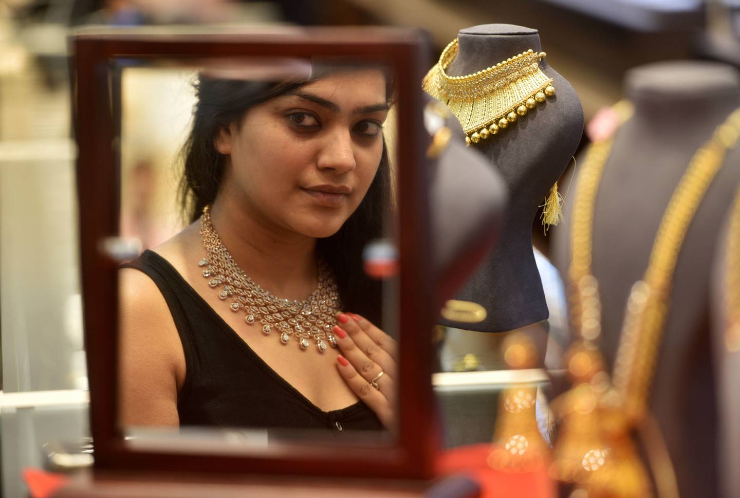 A woman buying jewellery on the occasion of Akshaya Tritiya at Kalyan Jewellers in Mumbai, India. Getty Images.
