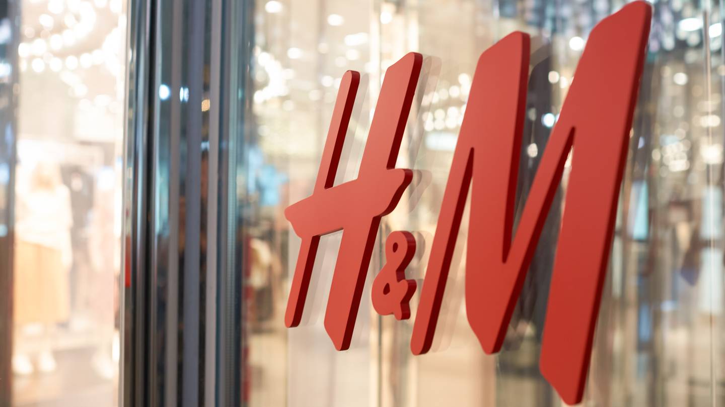 A close-up shot of the H&M logo on a storefront.