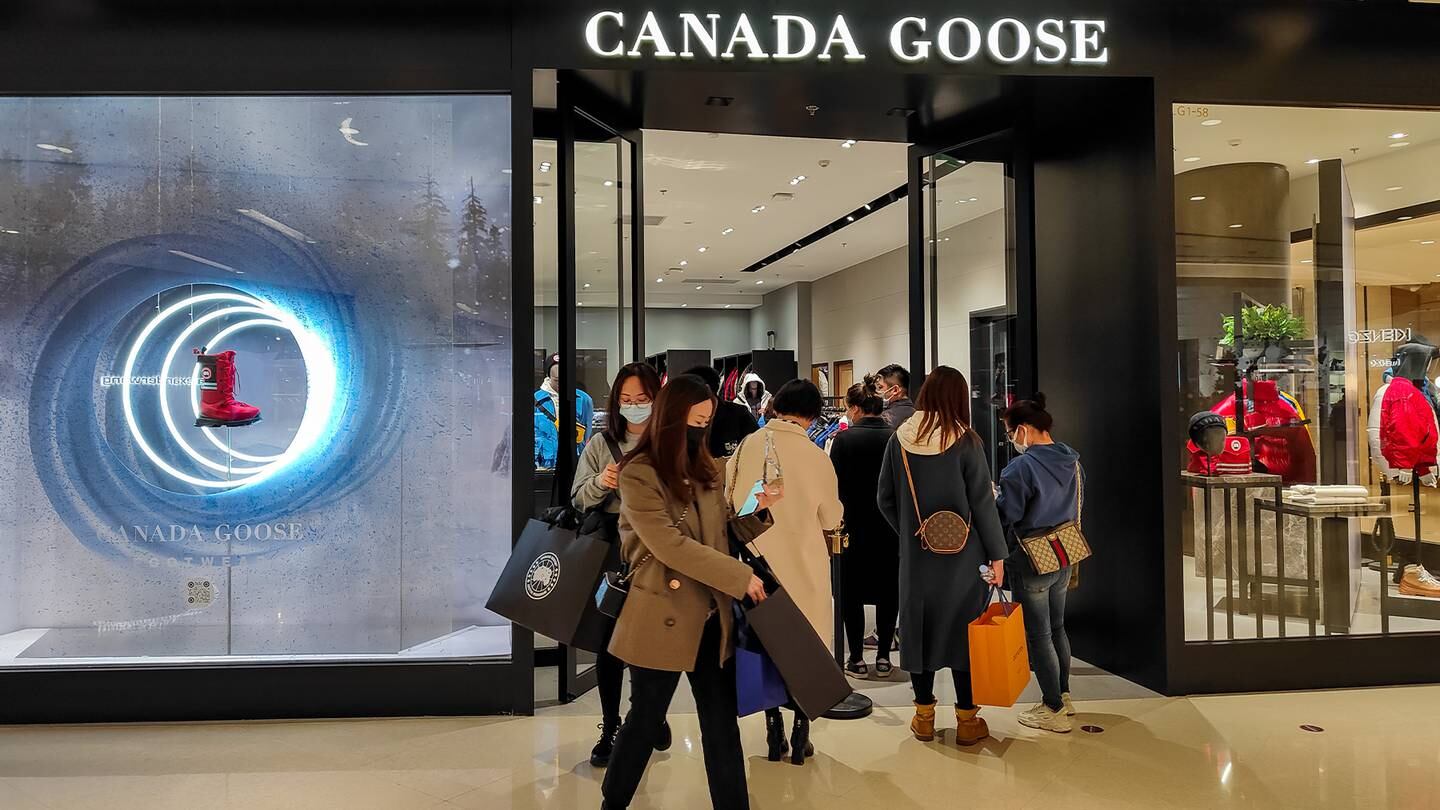 Customers wait in front of a Canada Goose store in Shanghai, China.
