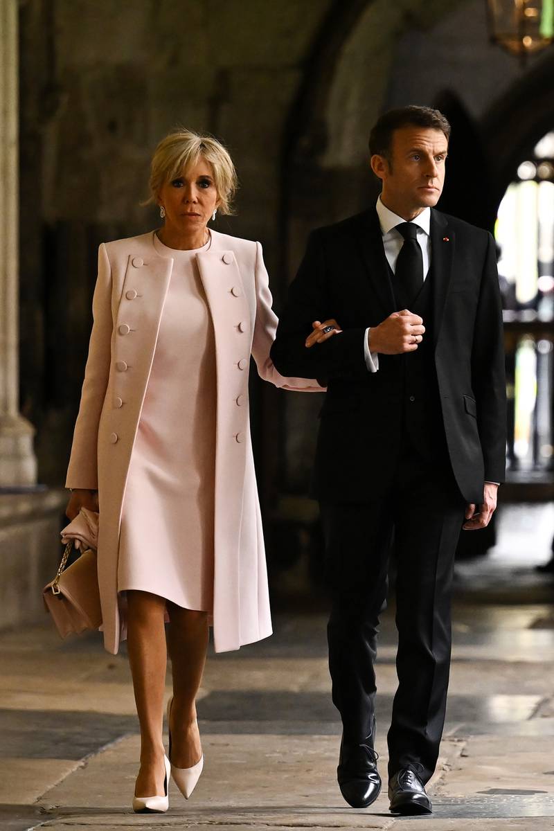 French President Emmanuel Macron with Brigitte Macron wearing an ensemble by Nicolas Ghesquière for Louis Vuitton.