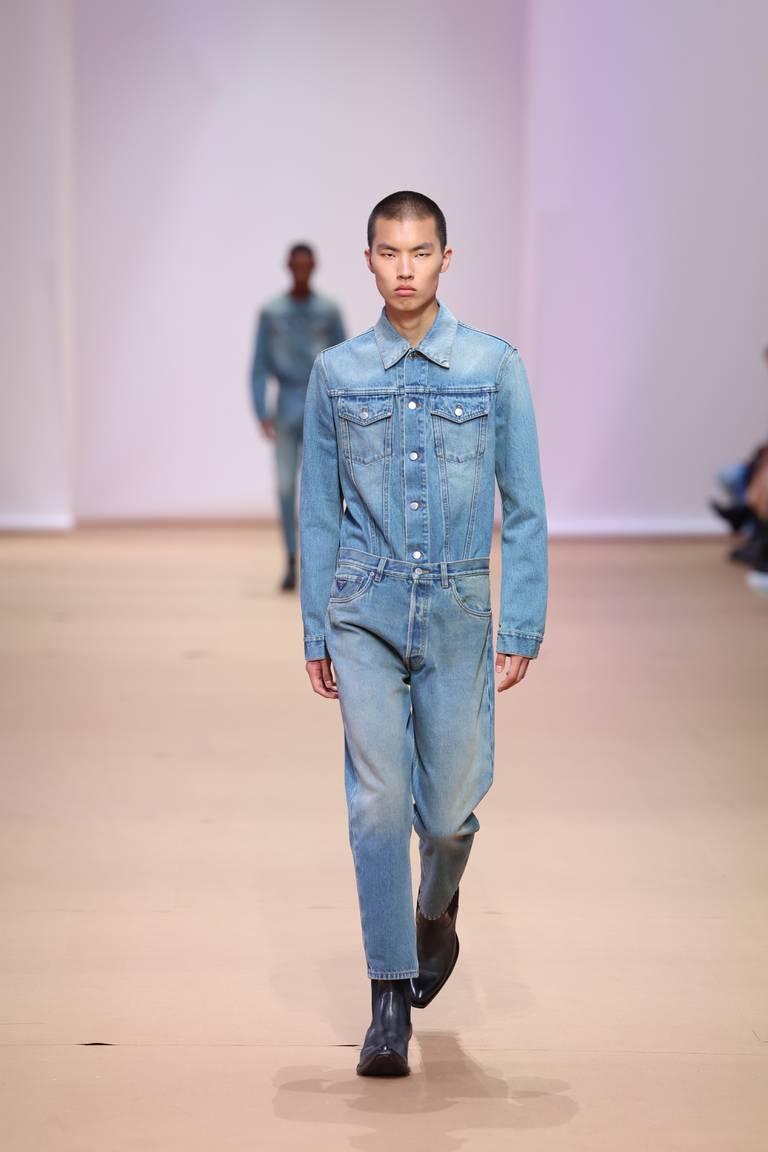 Model wearing all-denim Prada on the runway.