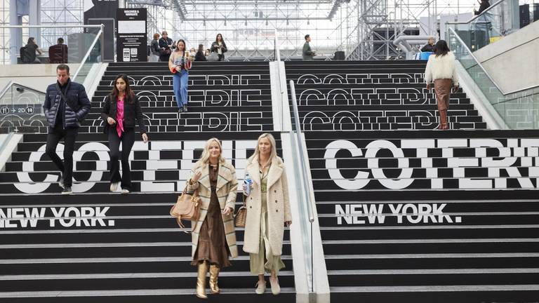 Visitors entering Coterie New York descending the stairs.