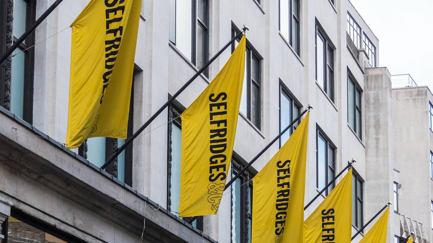 Yellow Selfridges flags hanging outside the department store.