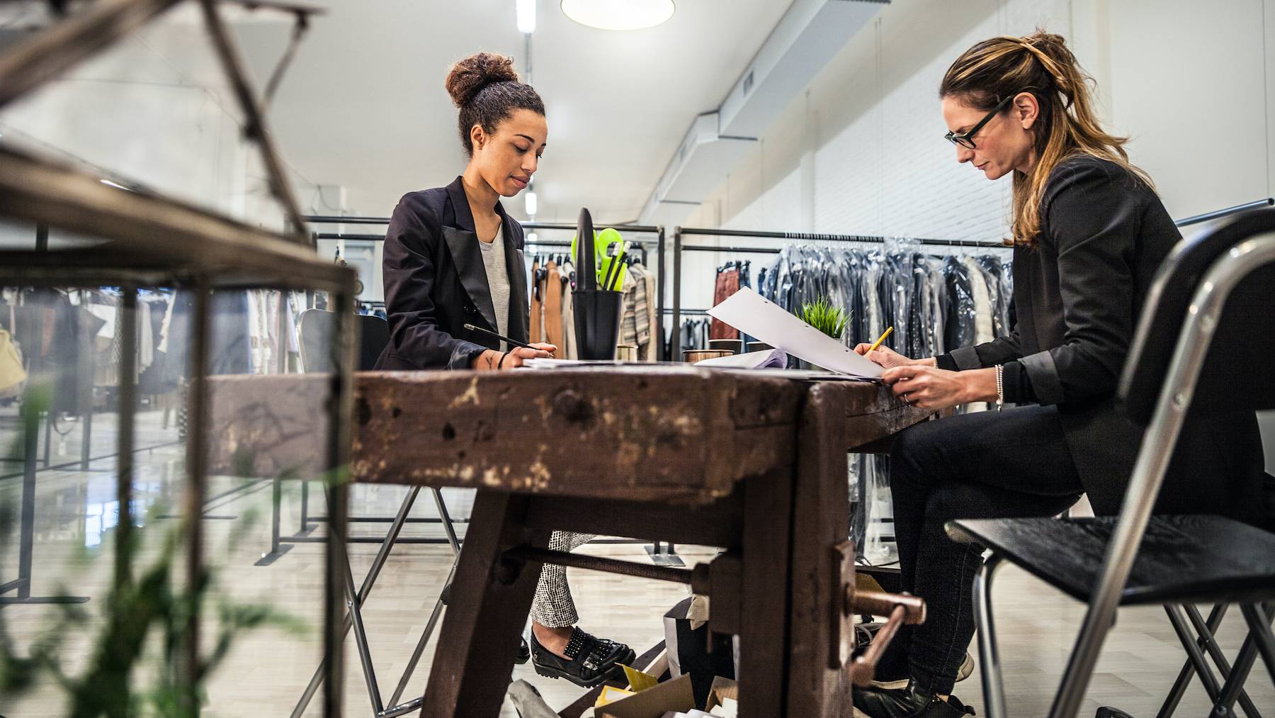 Two employees working through brand inventory.