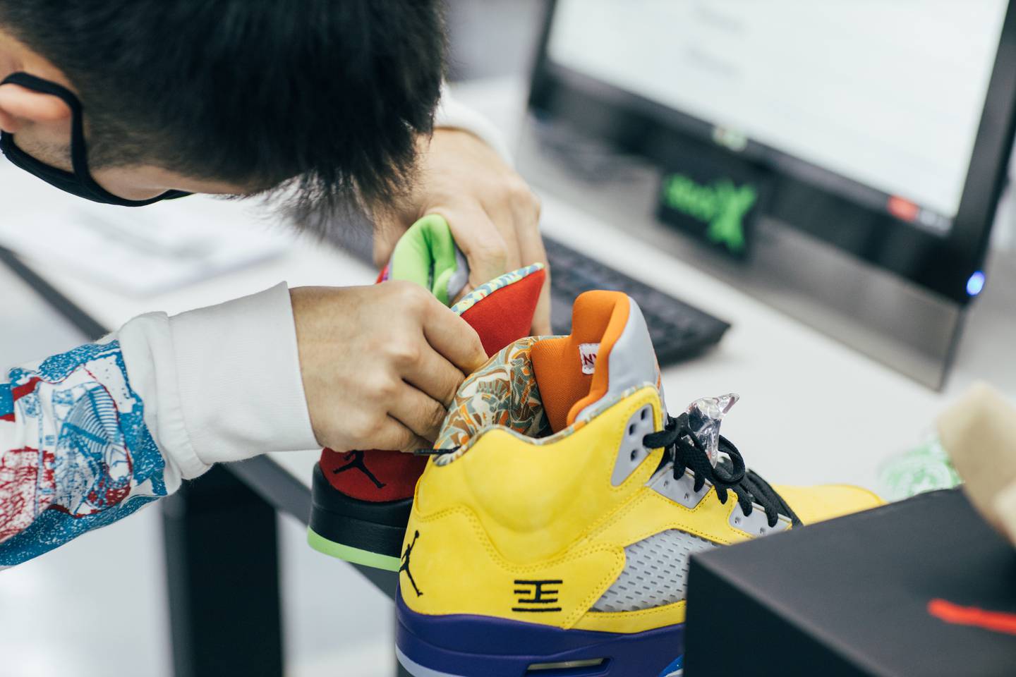 An authenticator studies a pair of sneakers at a StockX warehouse in Hong Kong.