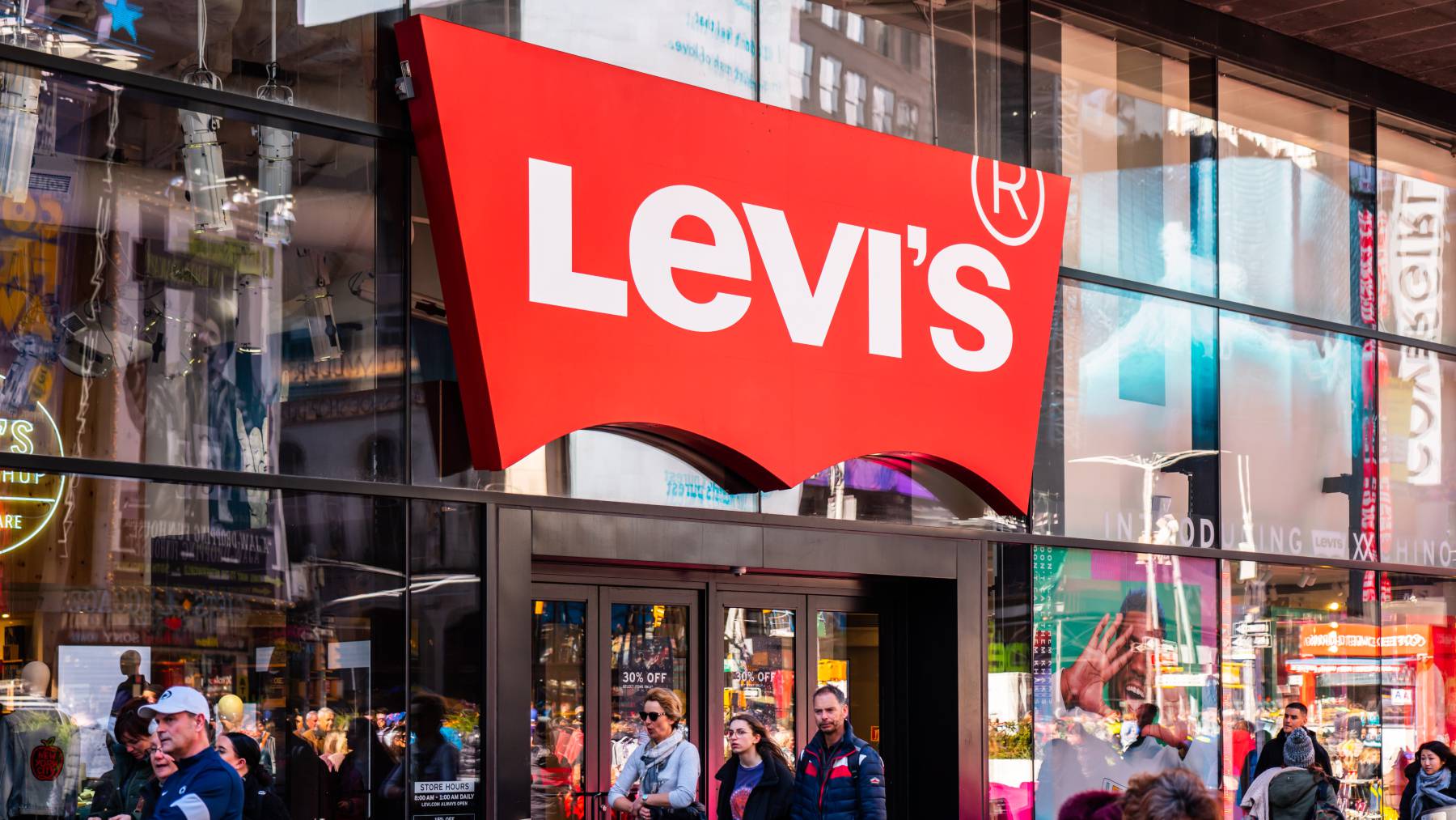 Pedestrians walk past a Levi's store in New York.