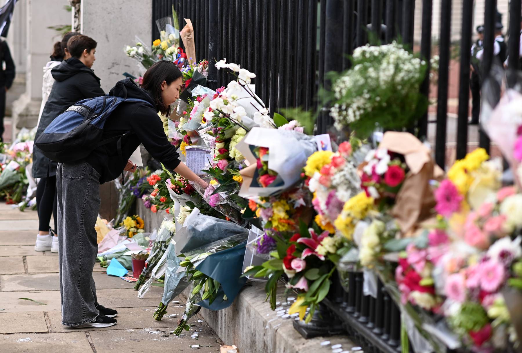 Tributes to Queen Elizabeth II are placed outside Buckingham Palace.