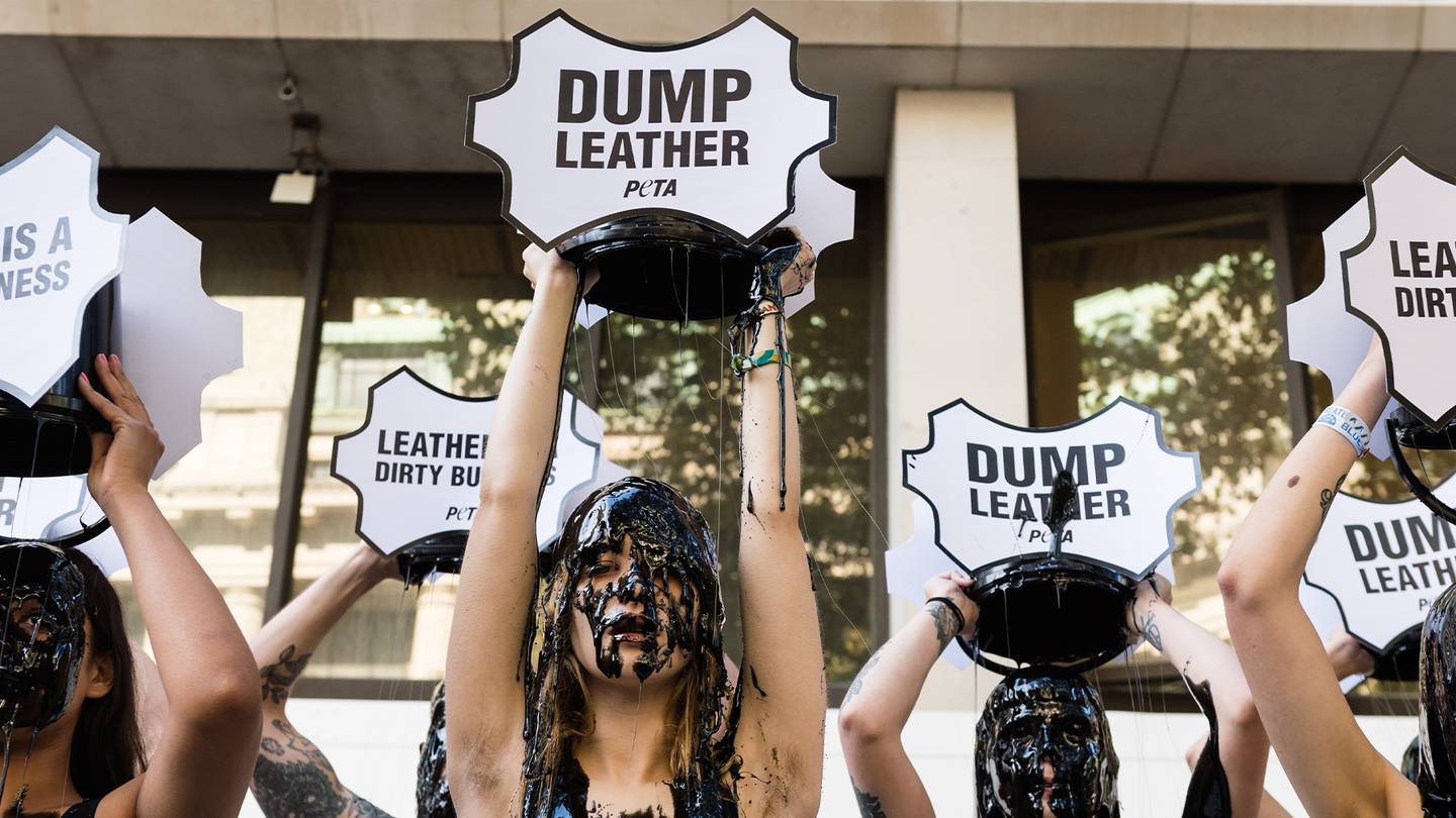 PETA activists douse themselves with black "toxic slime" outside London Fashion Week's main venue in 2019.