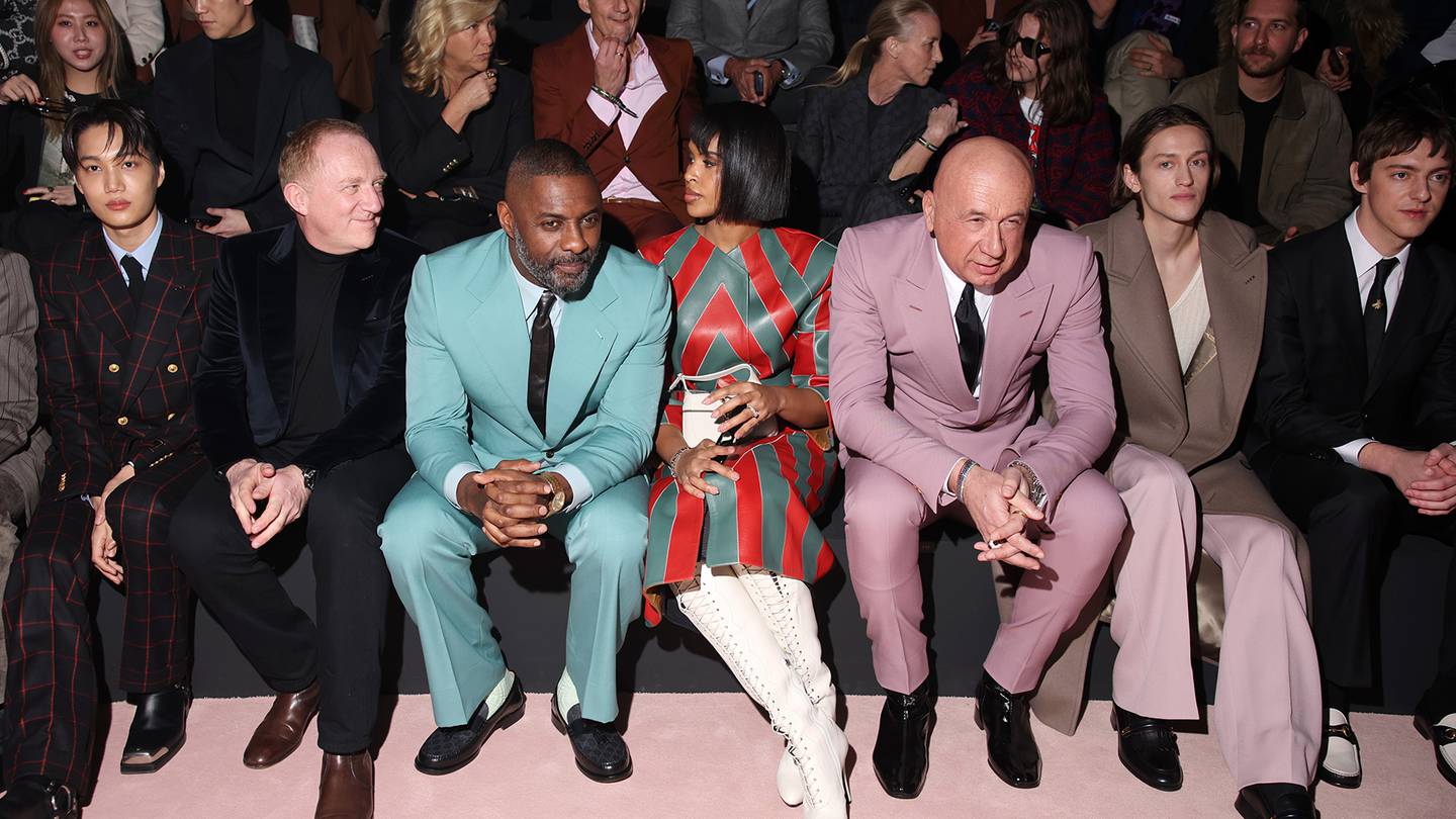 Kering chairman Francois-Henri Pinault sits between Kai and Idris Elba, near Gucci CEO Marco Bizzarri at brand's menswear show January 13, 2023. The brand hopes to reignite growth under a new designer.