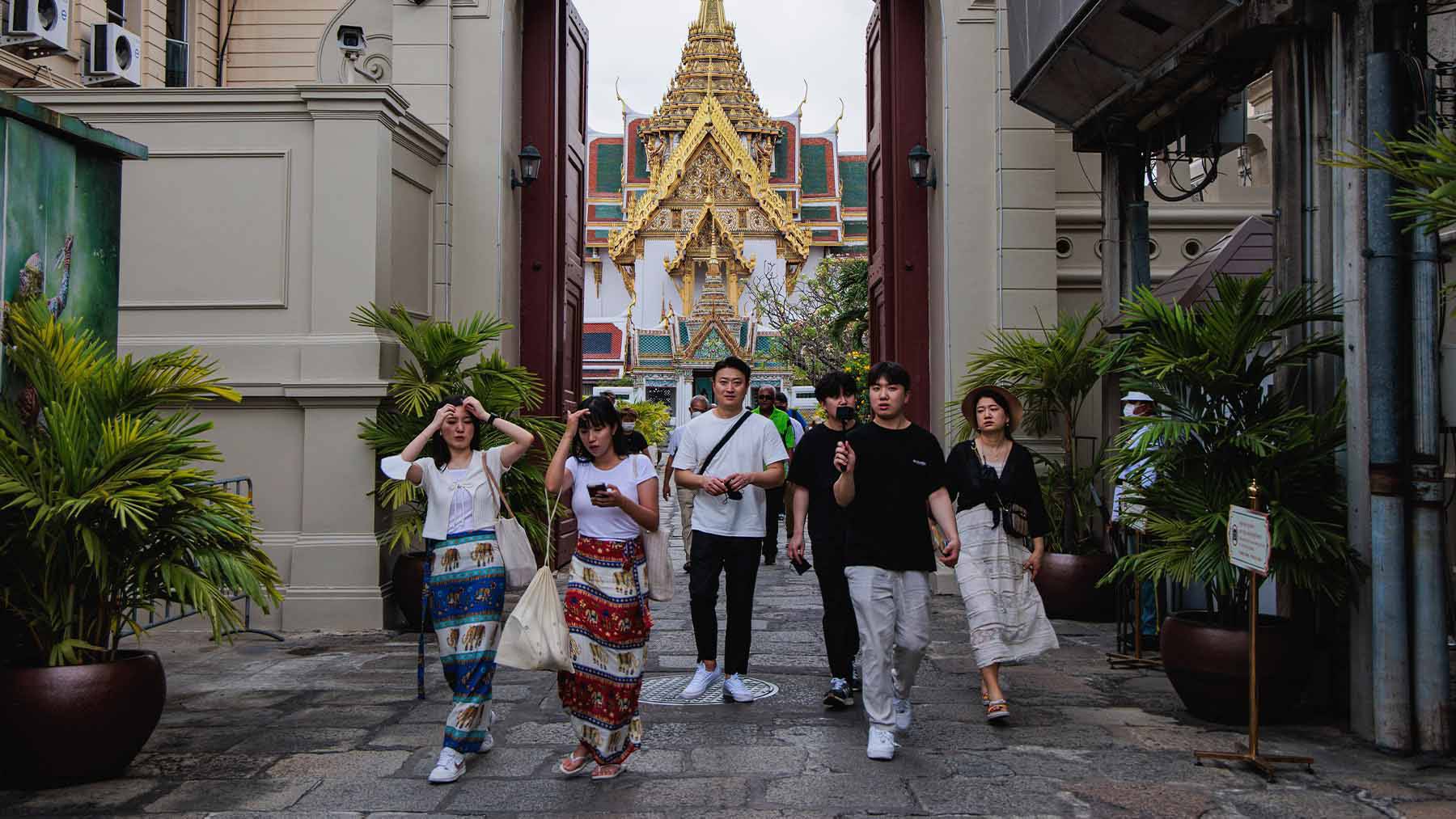 Tourists seen walking through The Grand Palace's gate in Bangkok.