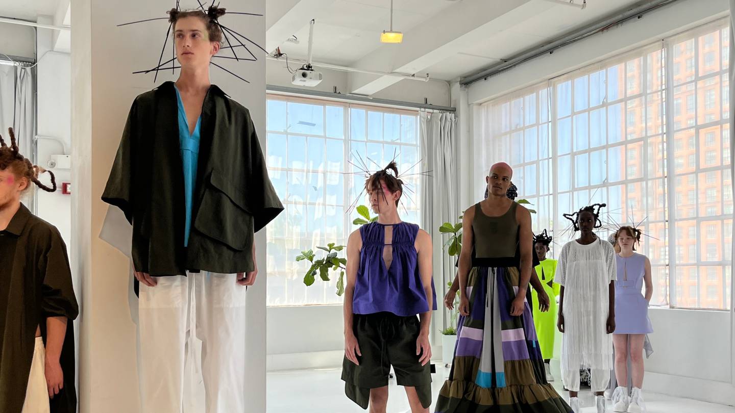 Models stand in a sunlit room wearing A.Potts' fluid, gender-inclusive clothing.