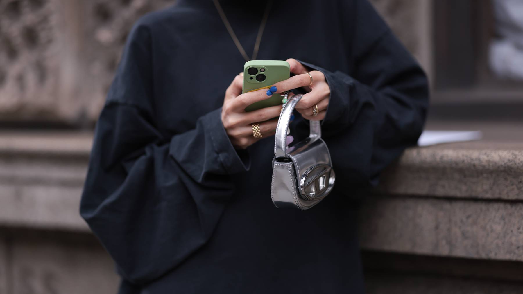 Customer holding a microbag and mobile phone.
