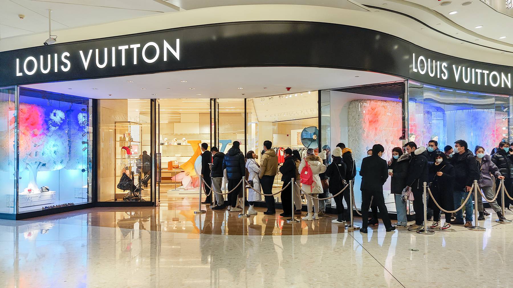 Customers wait in line to enter a Louis Vuitton shop in Shanghai. Getty Images.