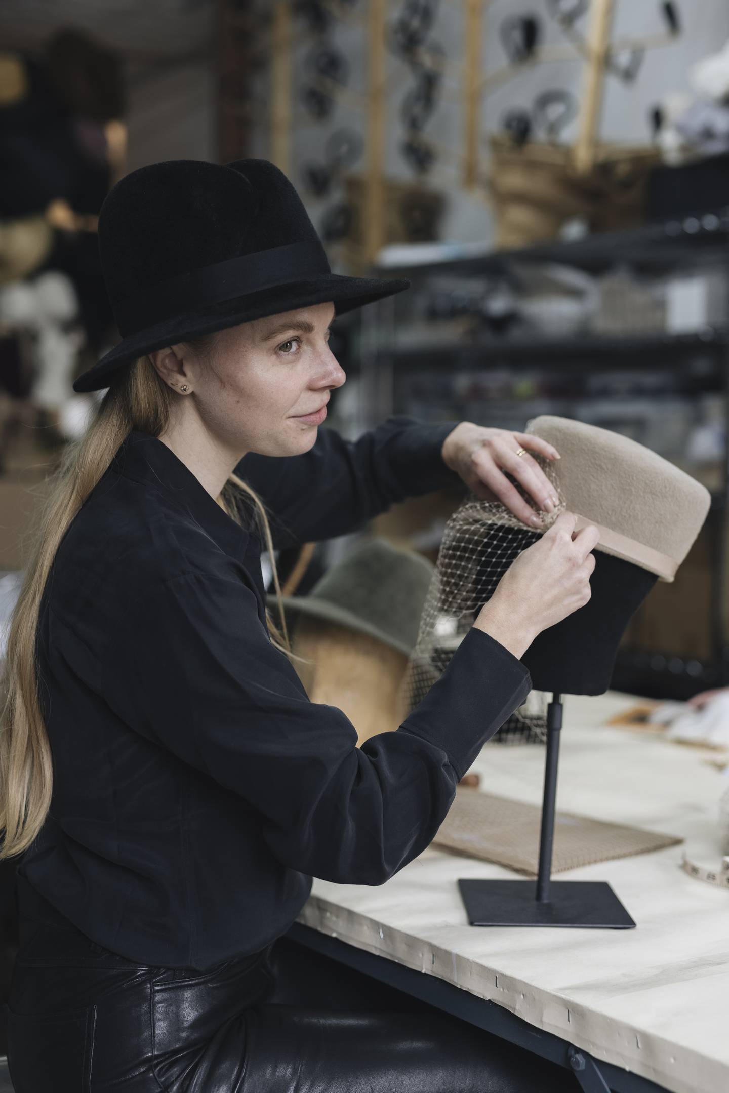Accessories designer and milliner Gigi Burris O'Hara, who is launching Closely Crafted, making a hat.
