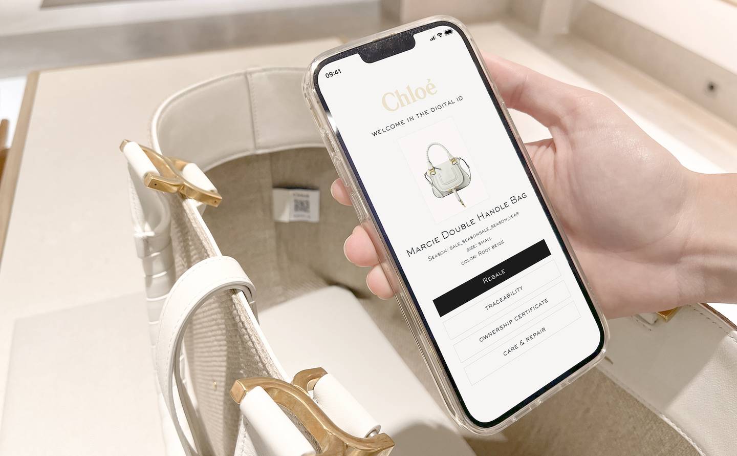An image of a phone hovering over a white handbag showing an example of one of digital product IDs Chloé is road testing.