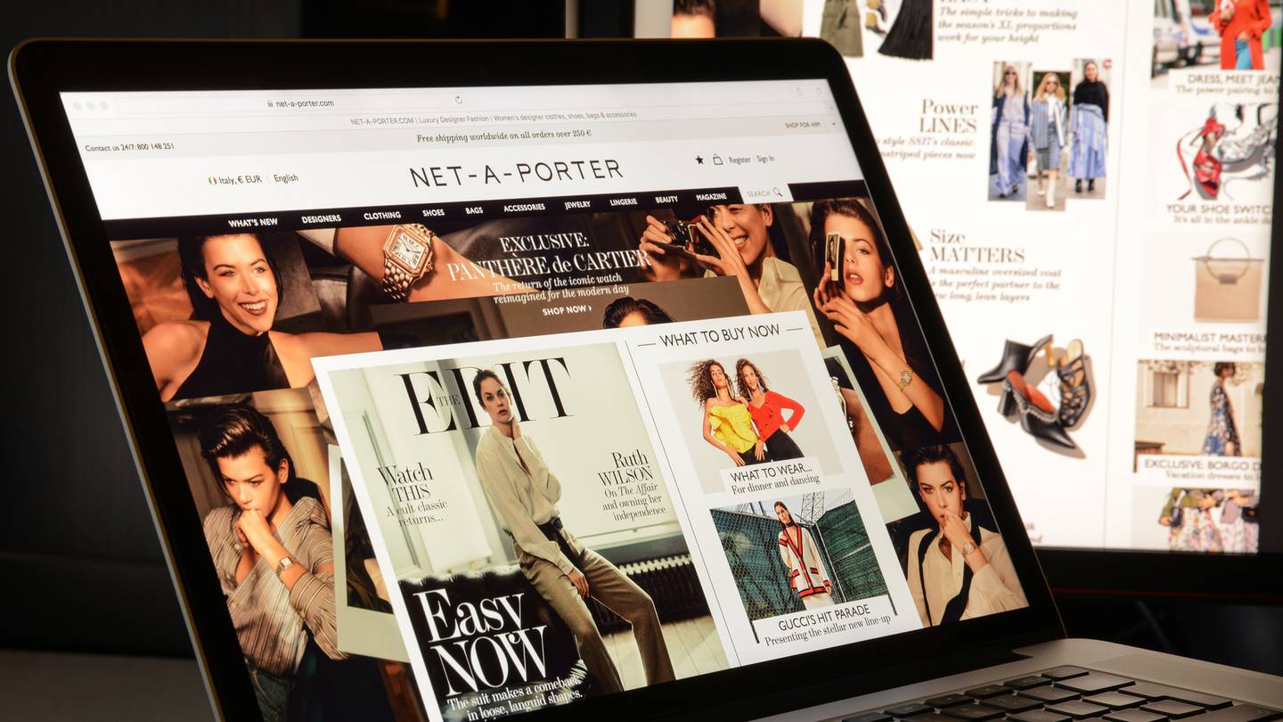 A Net-a-Porter homepage displaying a Cartier ad.