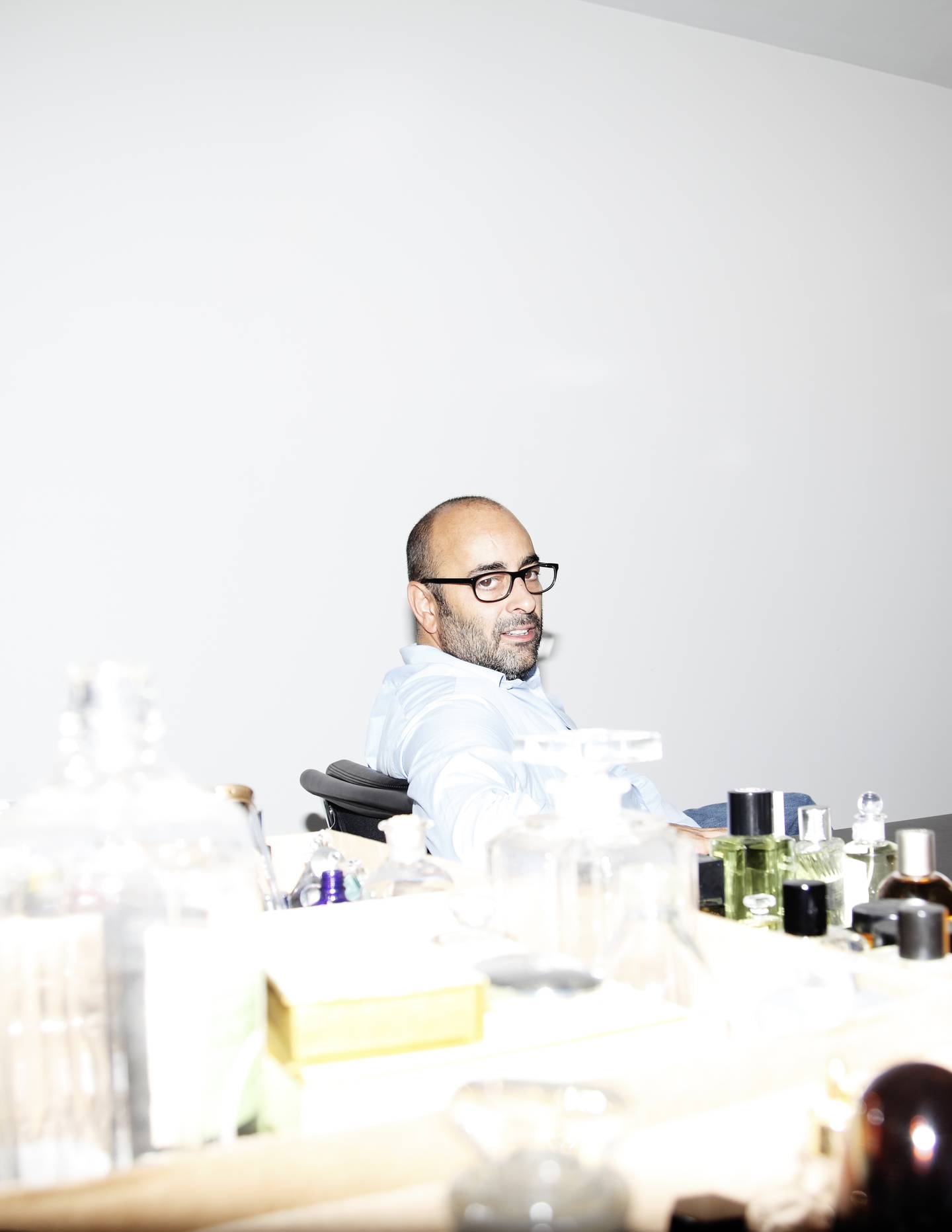 Fashion art director Ezra Petronio sitting at a desk.