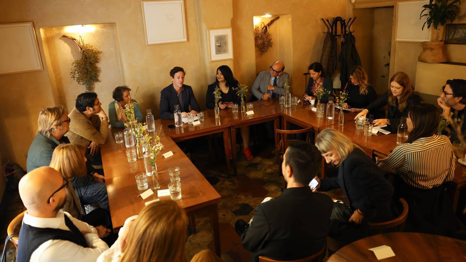 Attendees sat around a table at BoF x Shopify's co-hosted roundtable on "The Future of 'Made in Italy'" in Milan.
