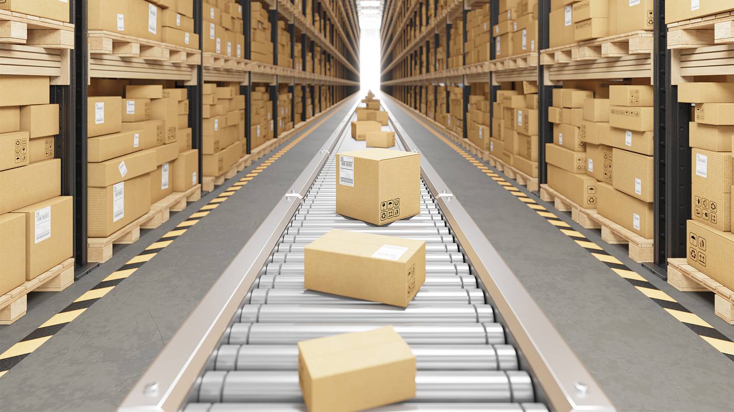 Boxes move down a conveyor belt in a warehouse.
