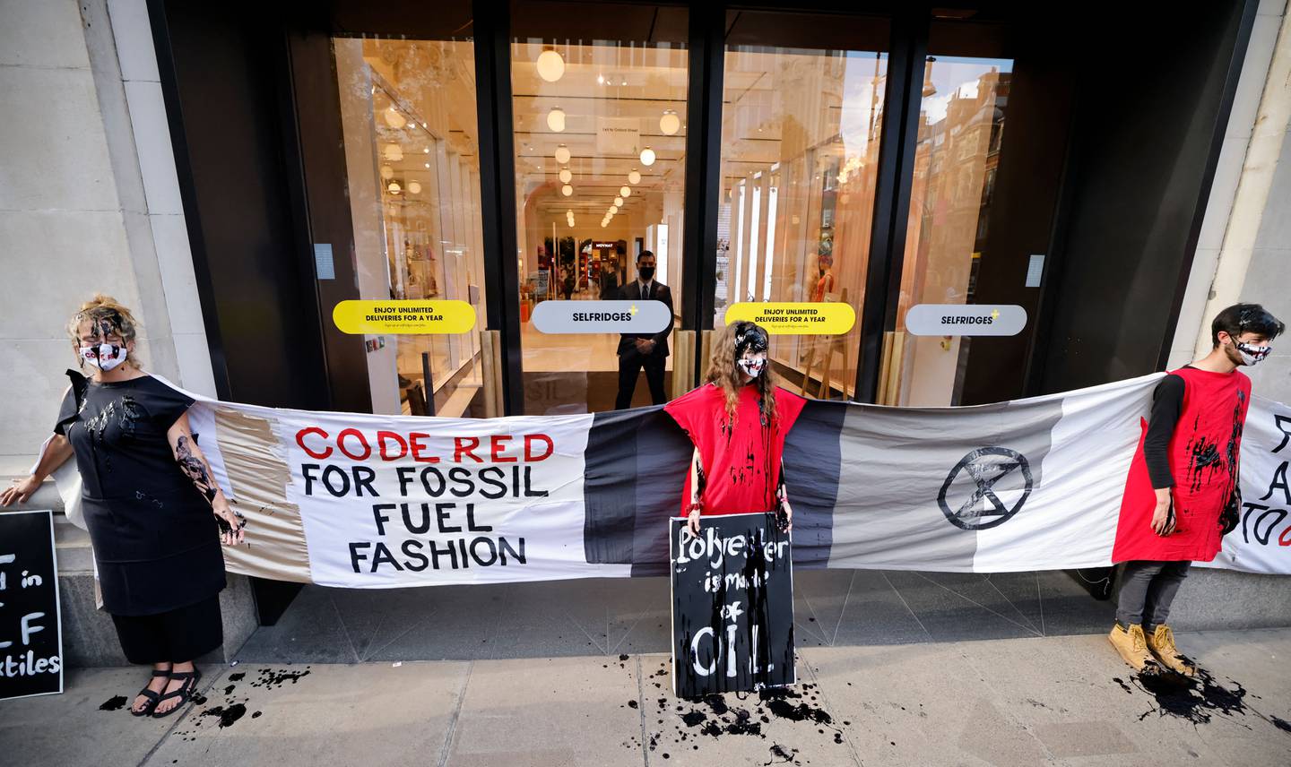 Activists from the Extinction Rebellion demonstrate outside Selfridges store in central London on August 24, 2021 during the group's 'Impossible Rebellion' series of actions.