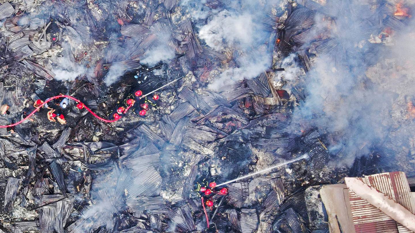 An aerial view of hundreds of firefighters in Dhaka, Bangladesh, to battle a huge fire that raged through Bongo Bazar market.