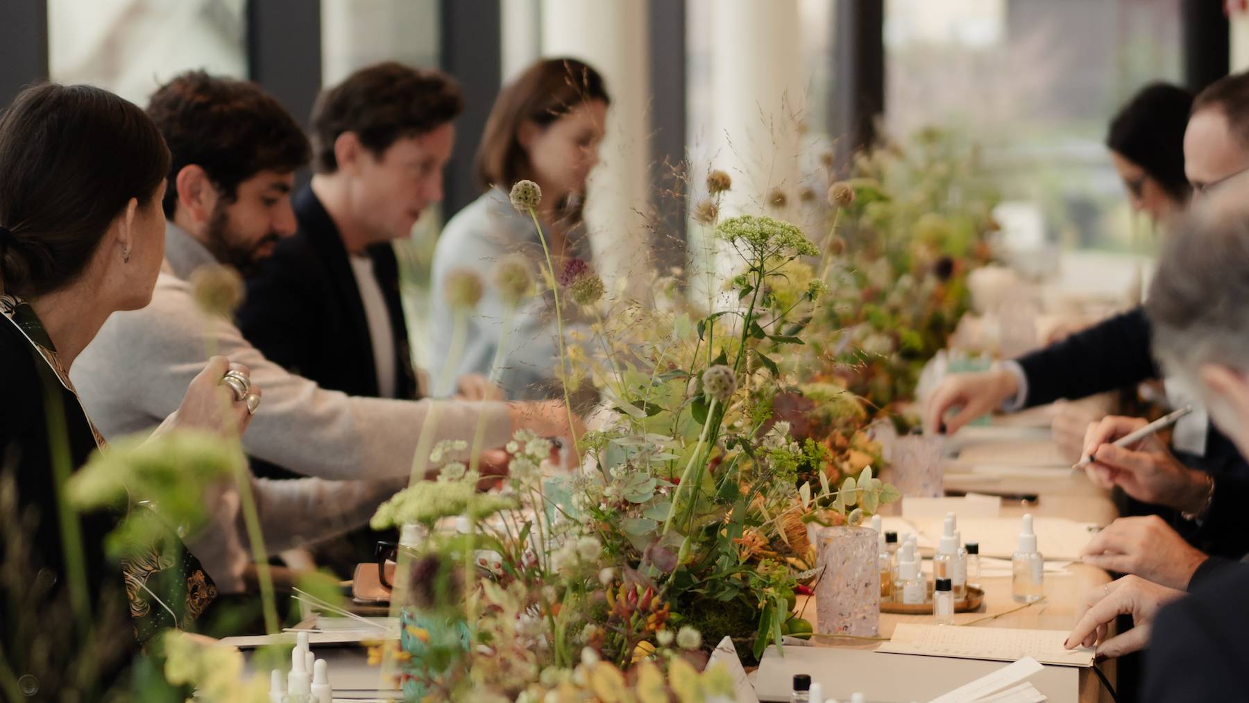 Attendees making perfurmes at a table during the Integra Fragrances x BoF executive breakfast and fragrance workshop.