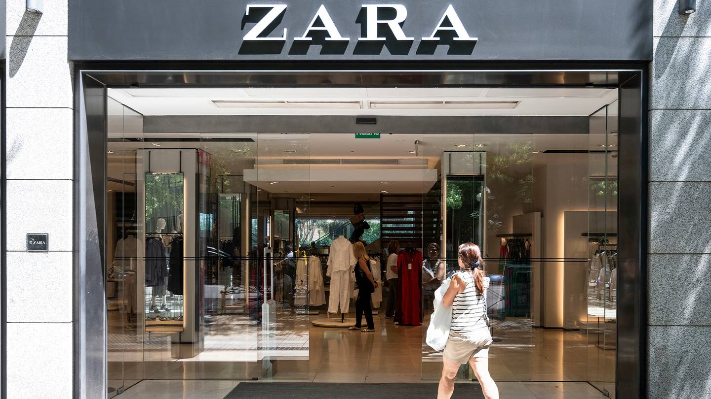 Zara store exterior with customer entering in the store doors.