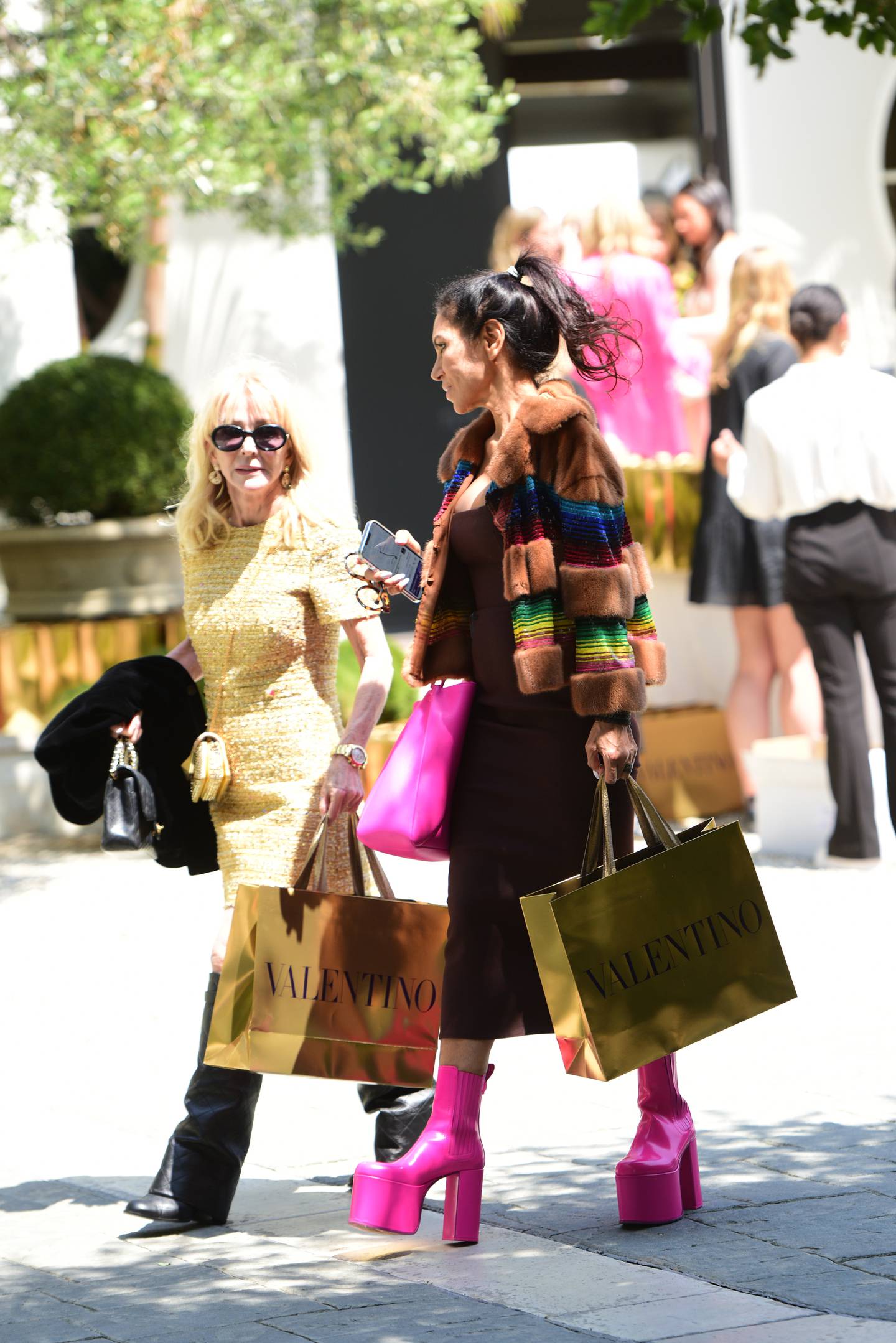 Two women shopping in Los Angeles holding Valentino bags.