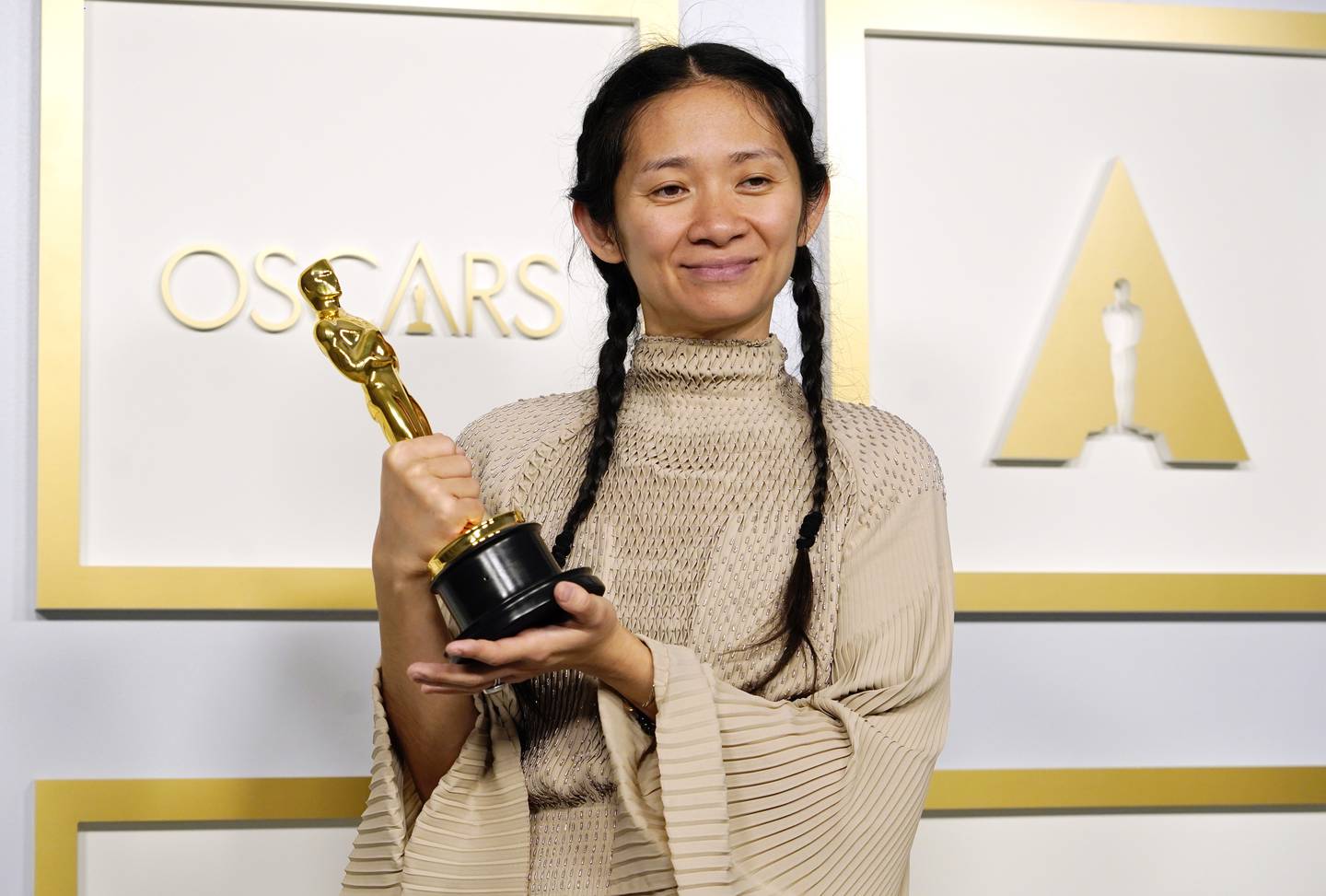 Chloe Zhao poses in the press room at the Oscars on Sunday, April 25, wearing Hermès. Getty.