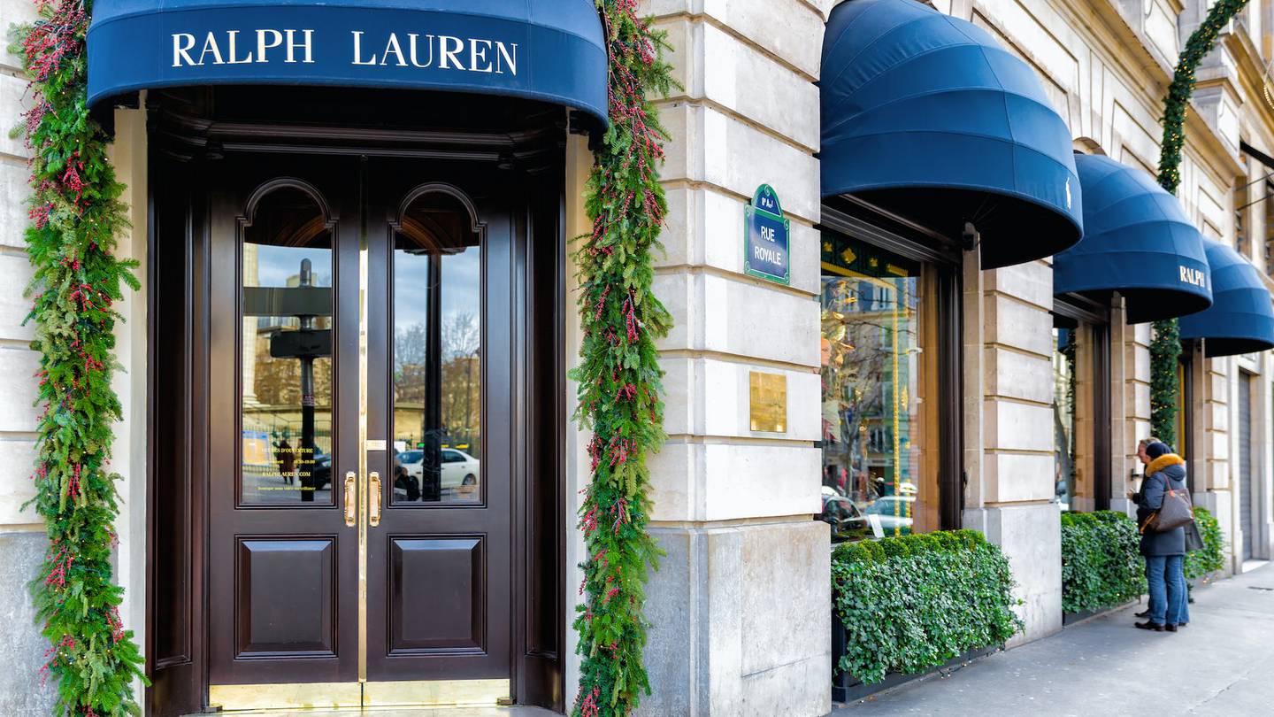 The exterior of a Ralph Lauren store with the logo over the doorway.