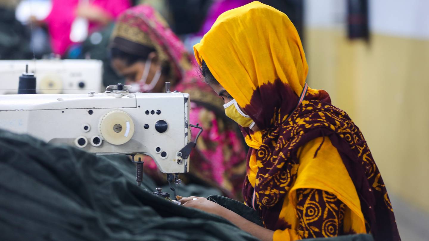 A garment worker sits at a sewing machine in a factory in Dhaka, Bangladesh.