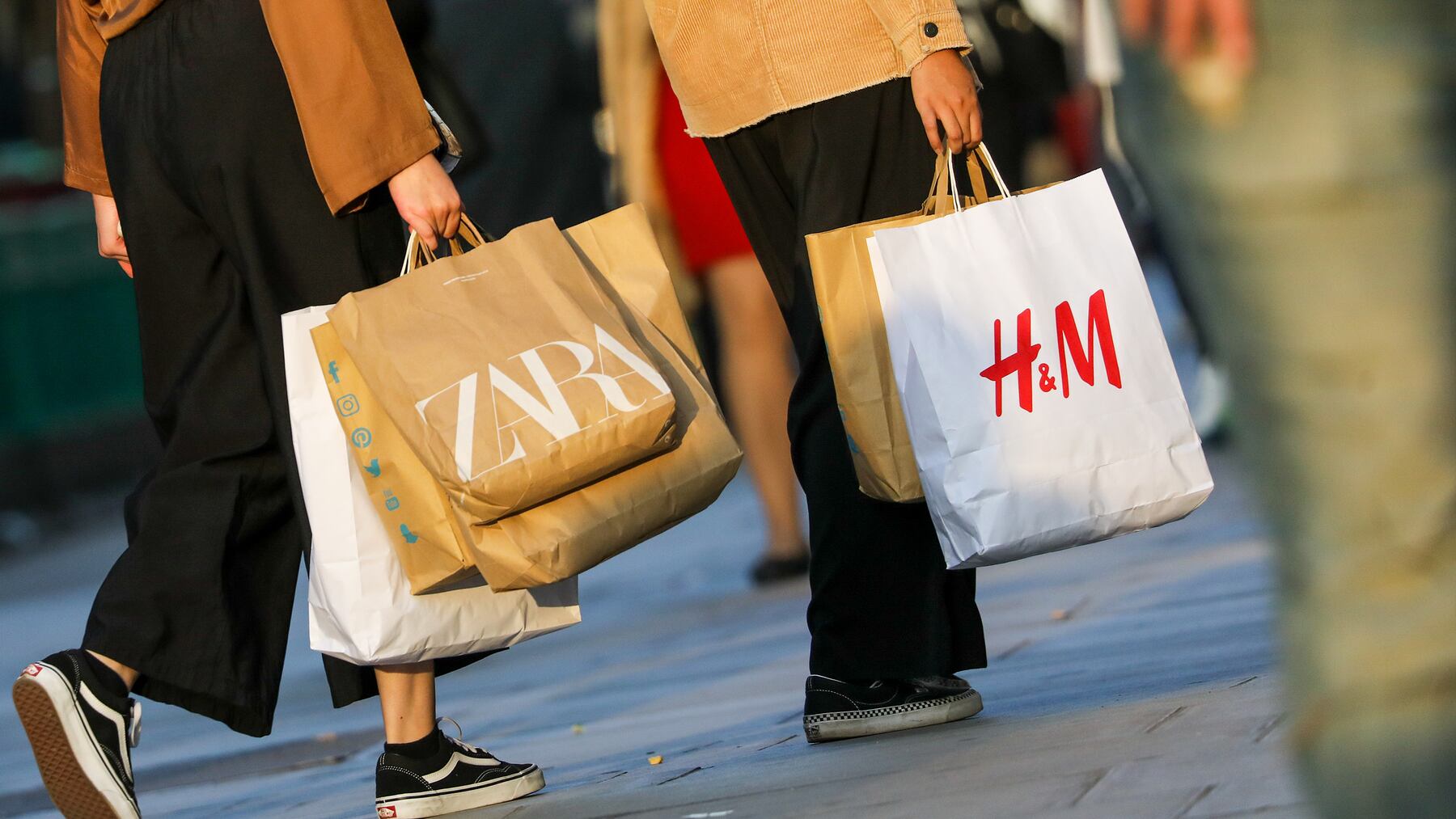 Shoppers carry Zara and H&M bags in London, UK. Getty Images.