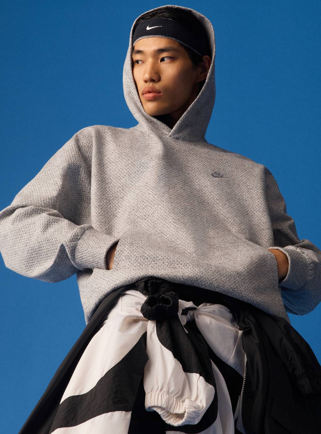 A model wears a Nike Forward hoodie.